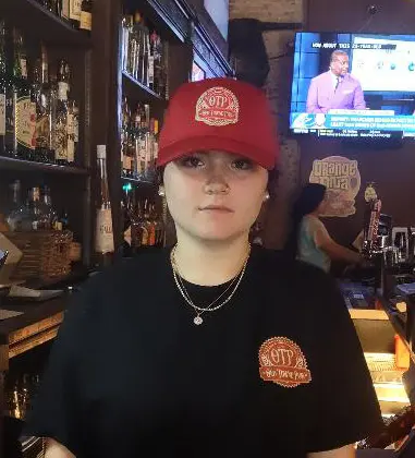 A red OTP cap with the Old Towne Pub seal embroidered on the front