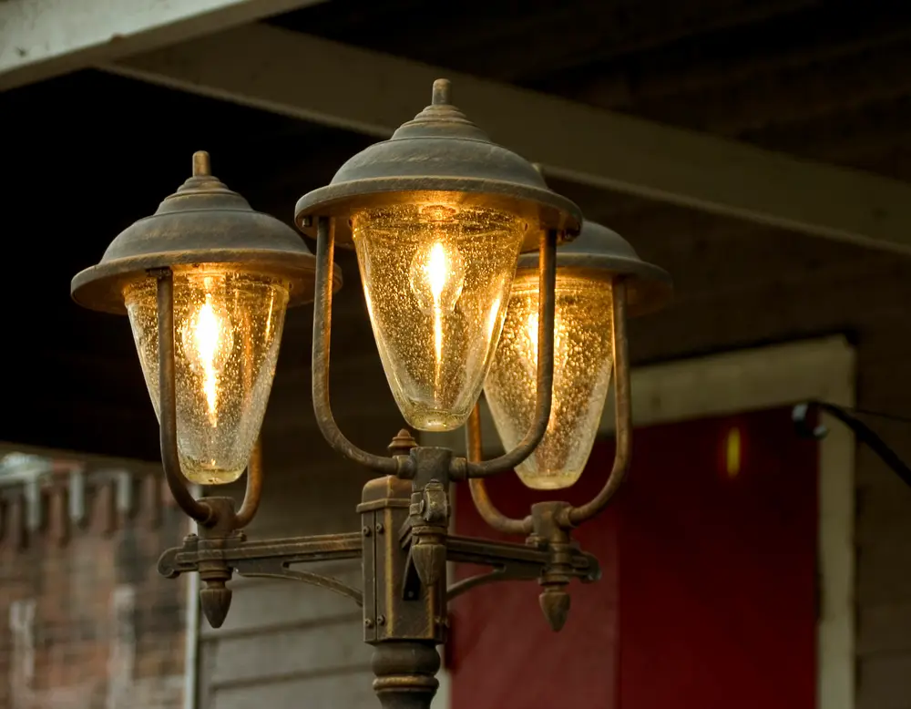 Warm glass lamps mounted on the brick wall inside Old Towne Pub