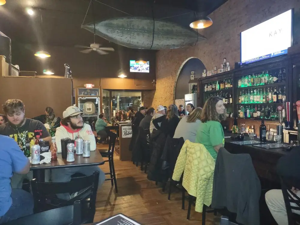 Guests sitting along the bar at Old Towne Pub on a busy evening